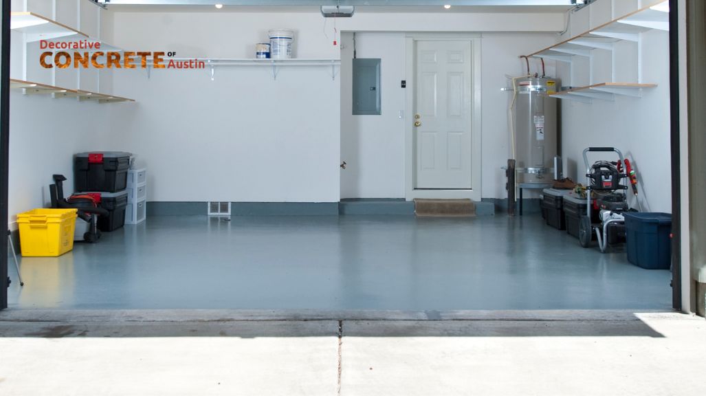 Wide view of a clean, organized garage with a smooth gray concrete floor.