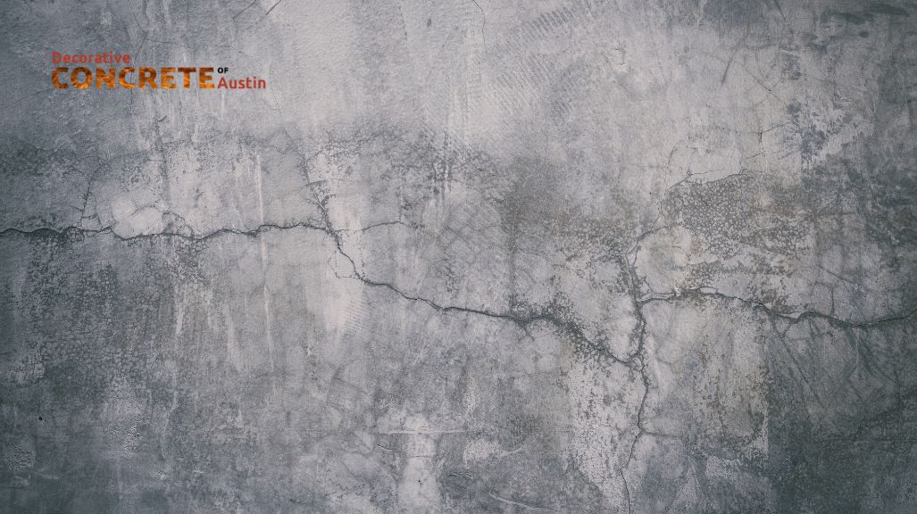 Rough gray concrete wall with visible cracks and textured details, conveying an industrial and rugged feel. 