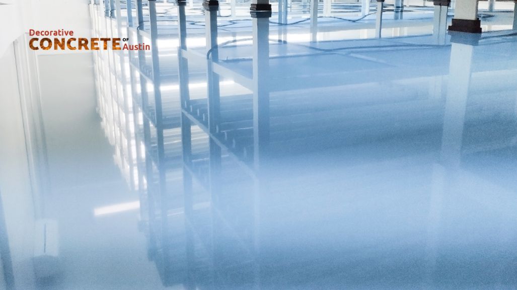 Shiny concrete floor reflecting industrial shelving, creating a modern, sleek appearance.