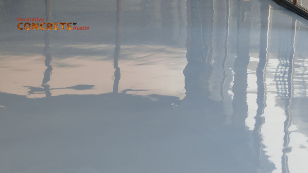 Smooth, glossy gray concrete floor with a reflective finish.