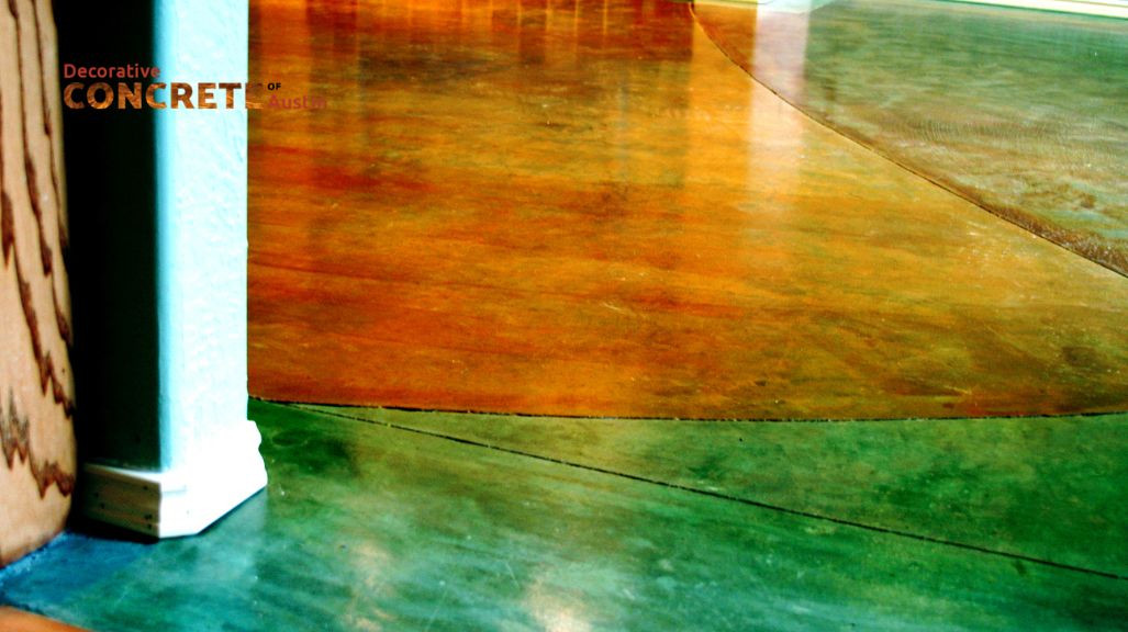 A polished concrete floor with a glossy finish features vibrant green and brown tones. The smooth surface reflects light, creating a modern, elegant atmosphere.