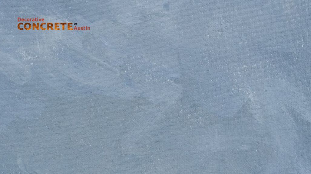 A textured light gray concrete surface with subtle brush strokes, featuring the text "Decorative Concrete of Austin" in the top left corner