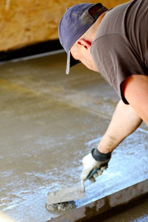 person leveling concrete